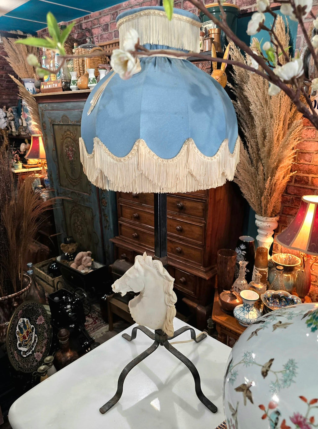 Vintage table lamp blue fabric shade and a white sculpted horse head bust on a black metal base