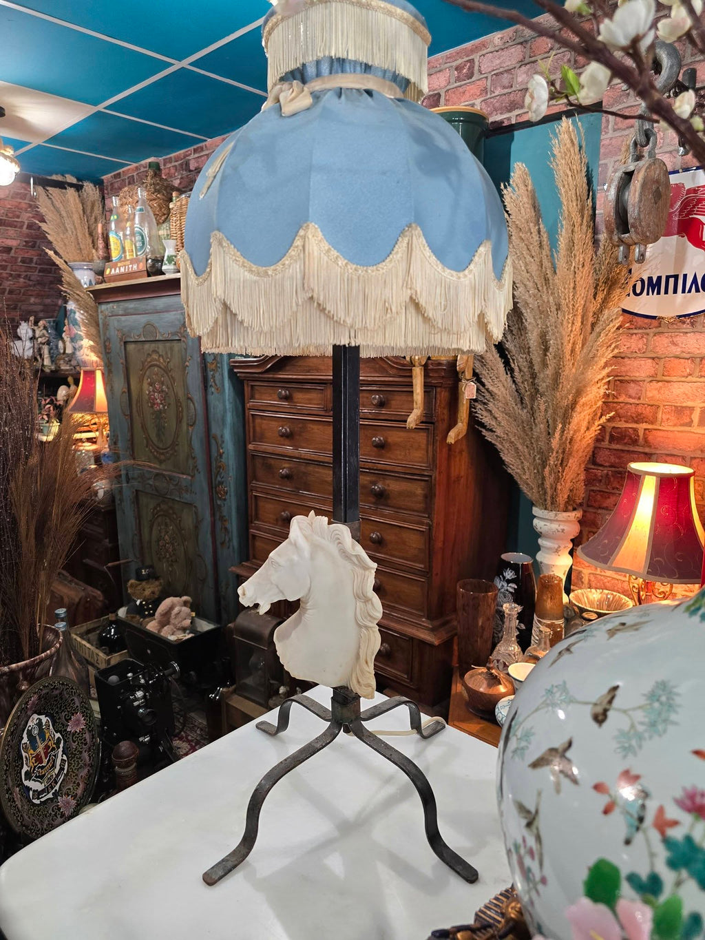 Vintage table lamp blue fabric shade and a white sculpted horse head bust on a black metal base