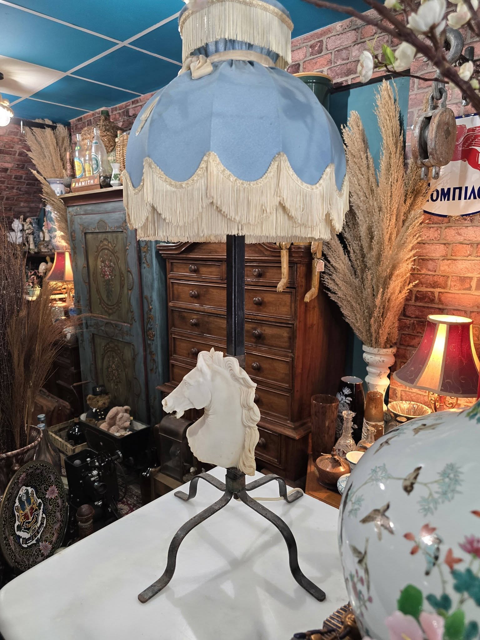Vintage table lamp blue fabric shade and a white sculpted horse head bust on a black metal base