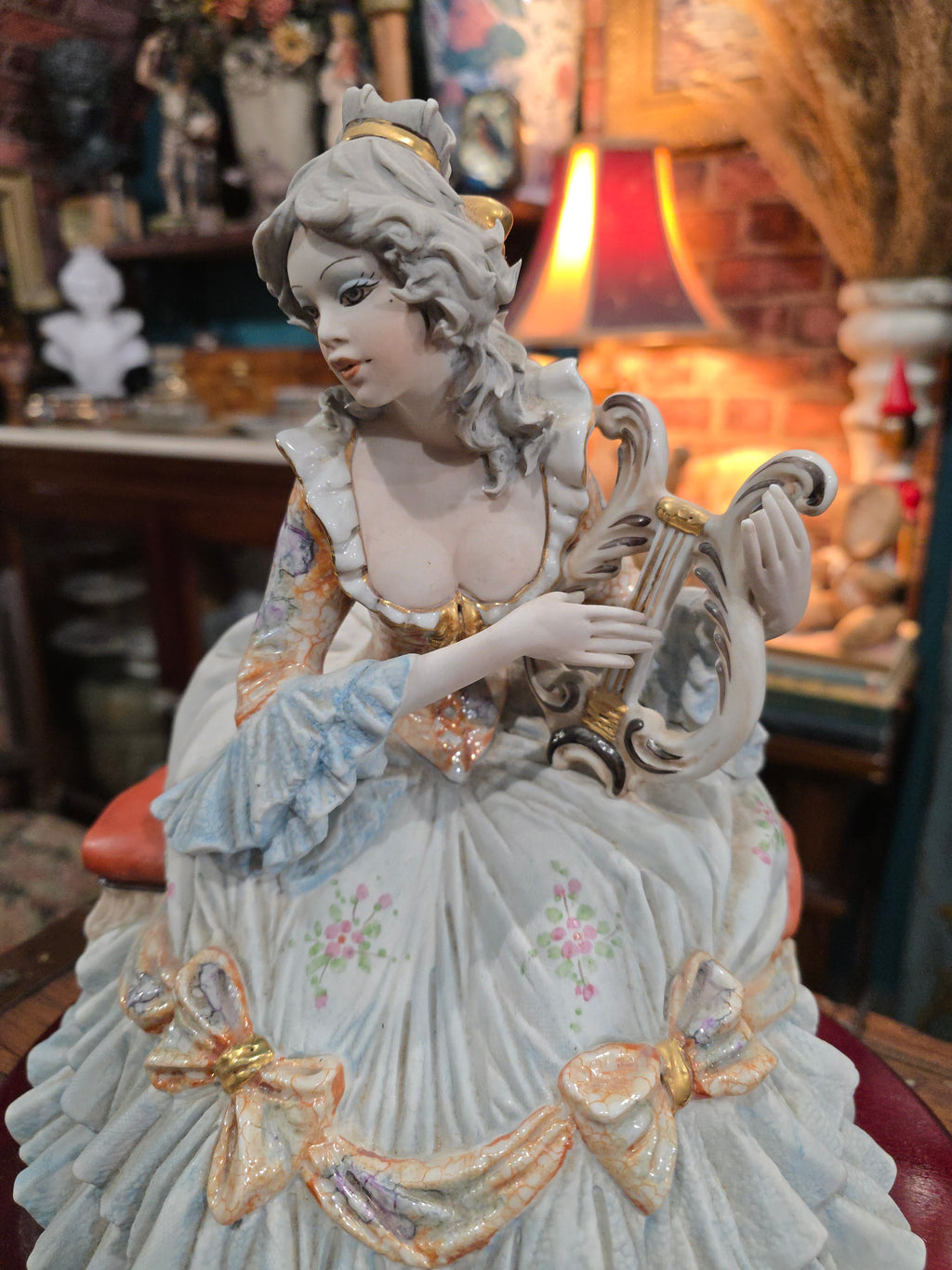 Vittorio Sabadin Italian porcelain figurine titled "Dame à la lyre"featuring a woman in a Rococo-style dress.
