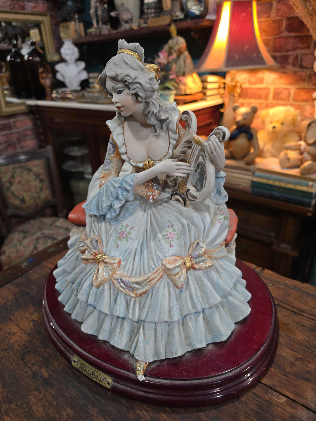 Vittorio Sabadin Italian porcelain figurine titled "Dame à la lyre"featuring a woman in a Rococo-style dress.