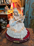 Vittorio Sabadin Italian porcelain figurine titled "Dame à la lyre"featuring a woman in a Rococo-style dress.