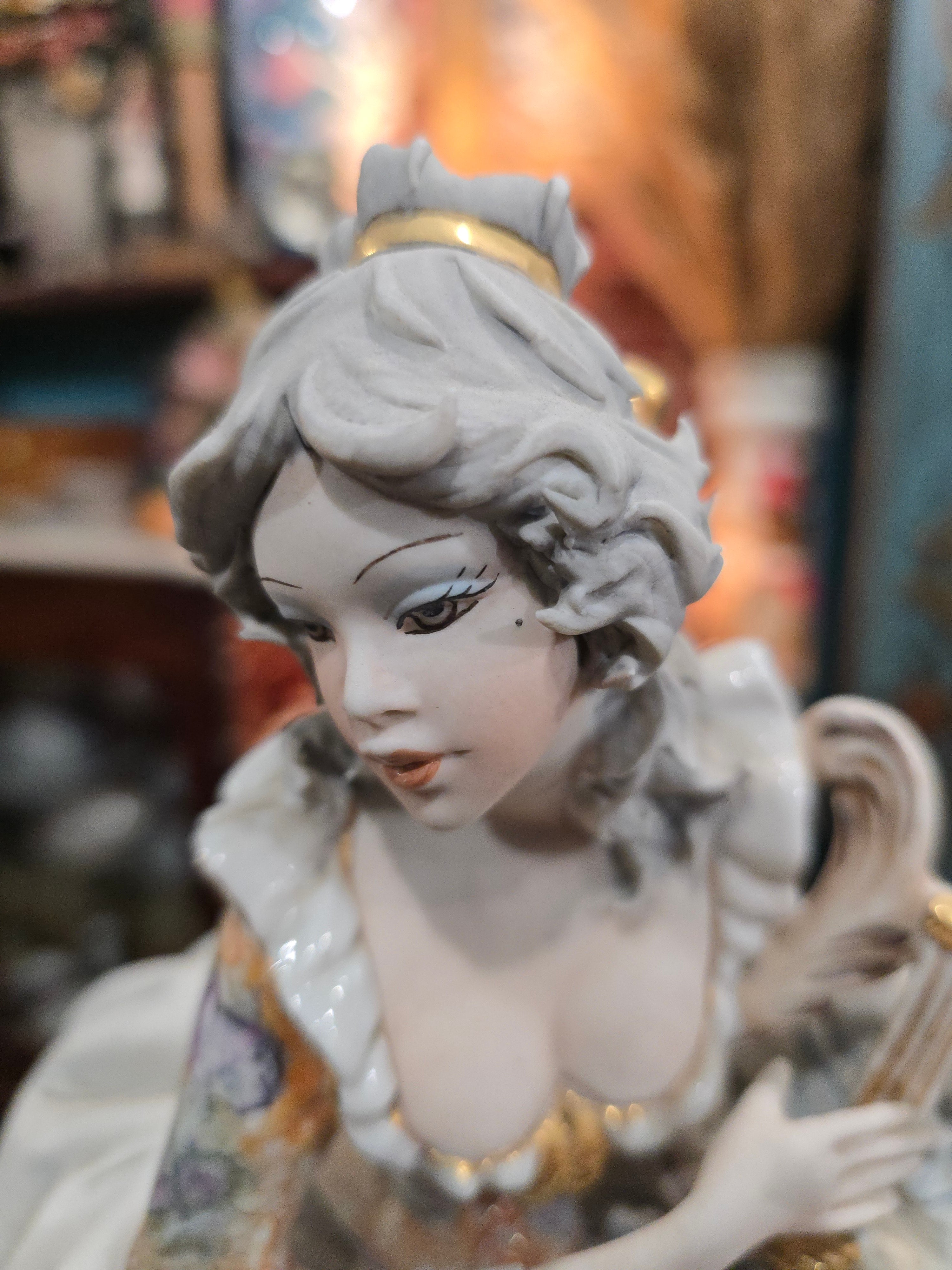 Vittorio Sabadin Italian porcelain figurine titled "Dame à la lyre"featuring a woman in a Rococo-style dress.