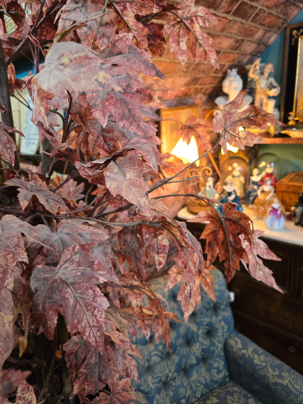 Artificial maple tree with maroon autumn-colored foliage with , blue-and-white porcelain cache-pot