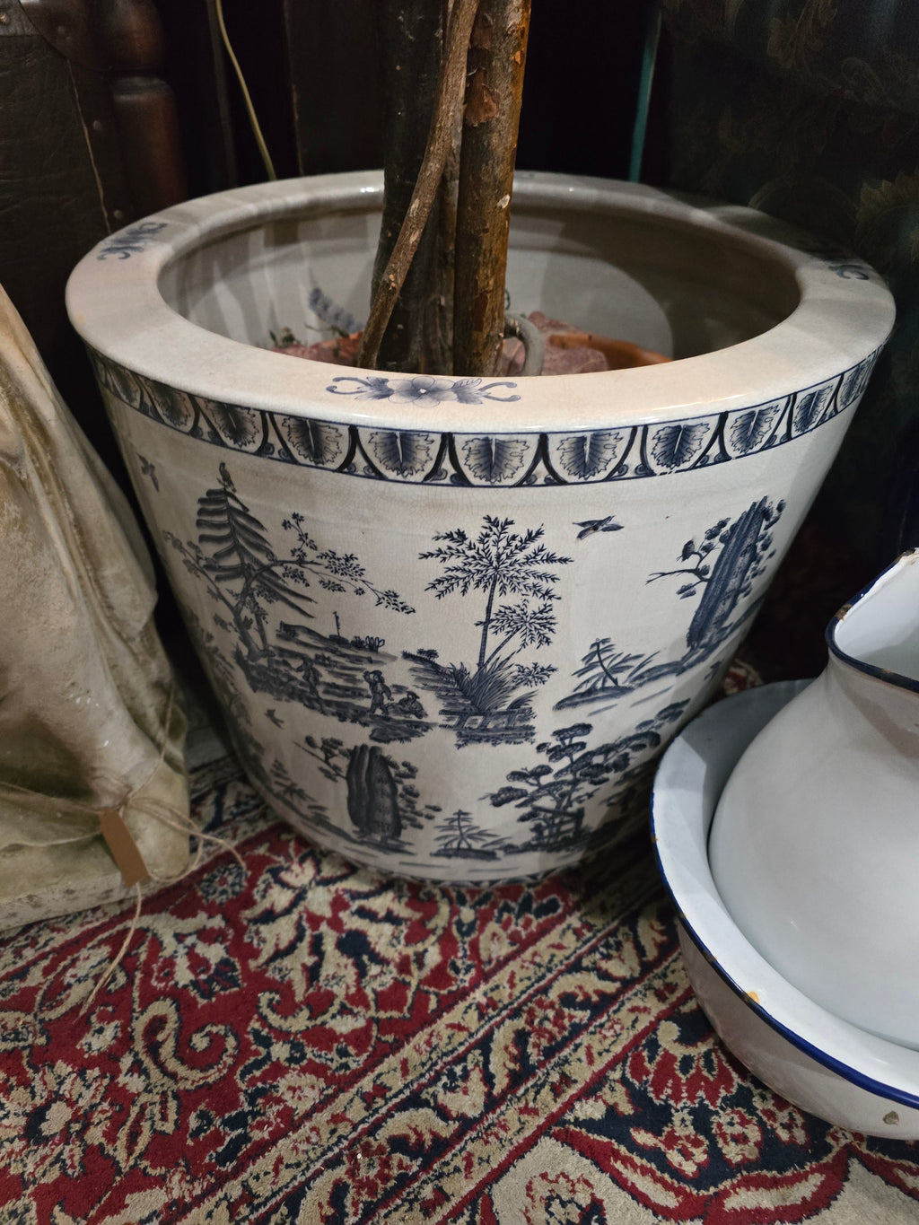 Artificial maple tree with maroon autumn-colored foliage with , blue-and-white porcelain cache-pot