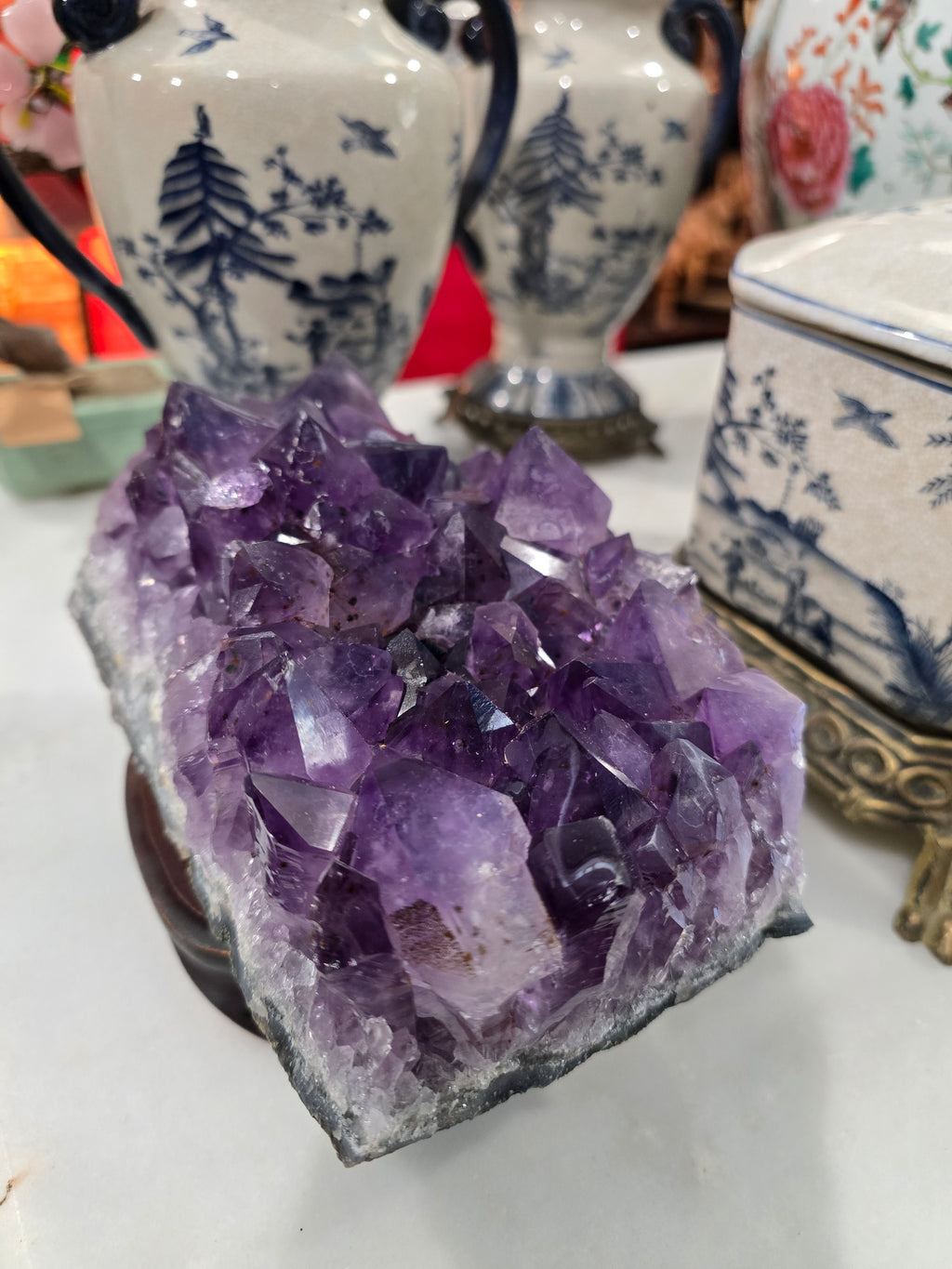 Vintage amethyst crystal cluster on a wooden stand