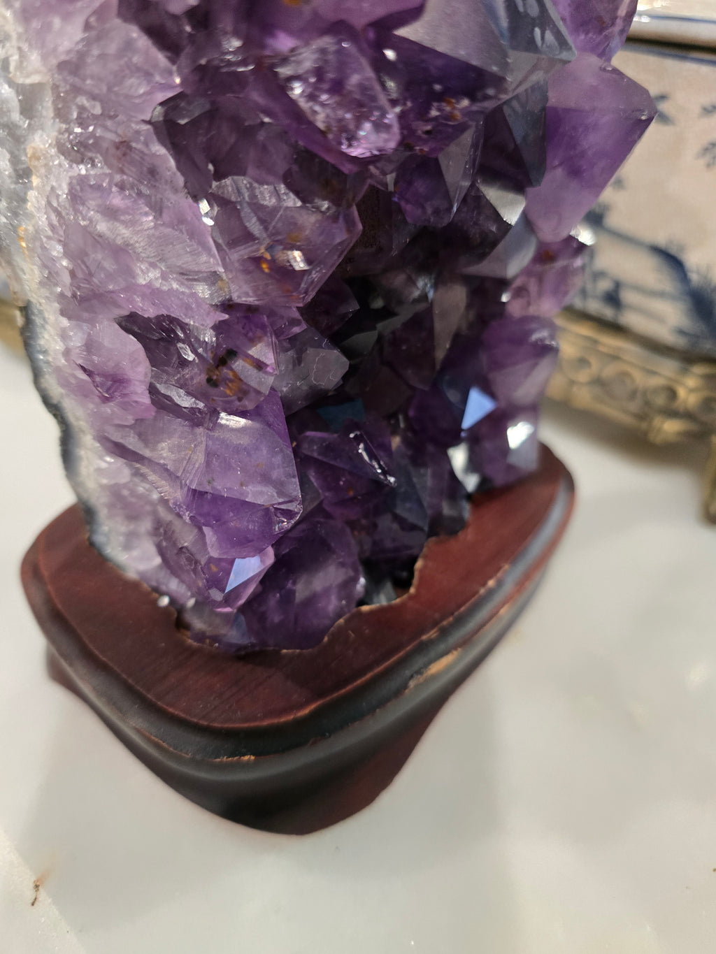 Vintage amethyst crystal cluster on a wooden stand