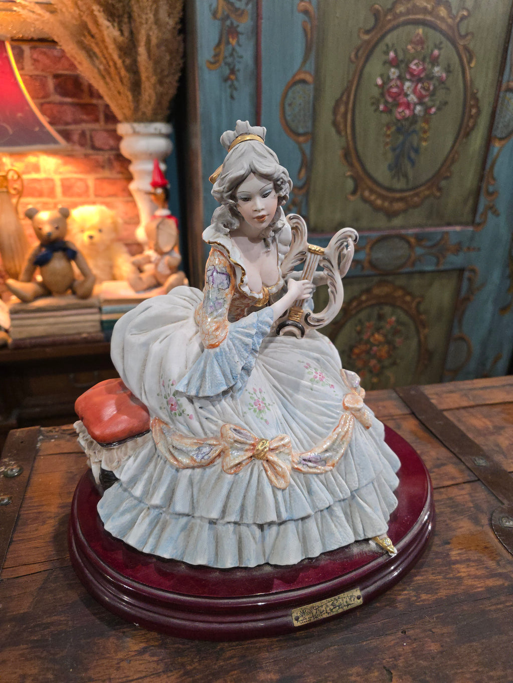 Vittorio Sabadin Italian porcelain figurine titled "Dame à la lyre"featuring a woman in a Rococo-style dress.