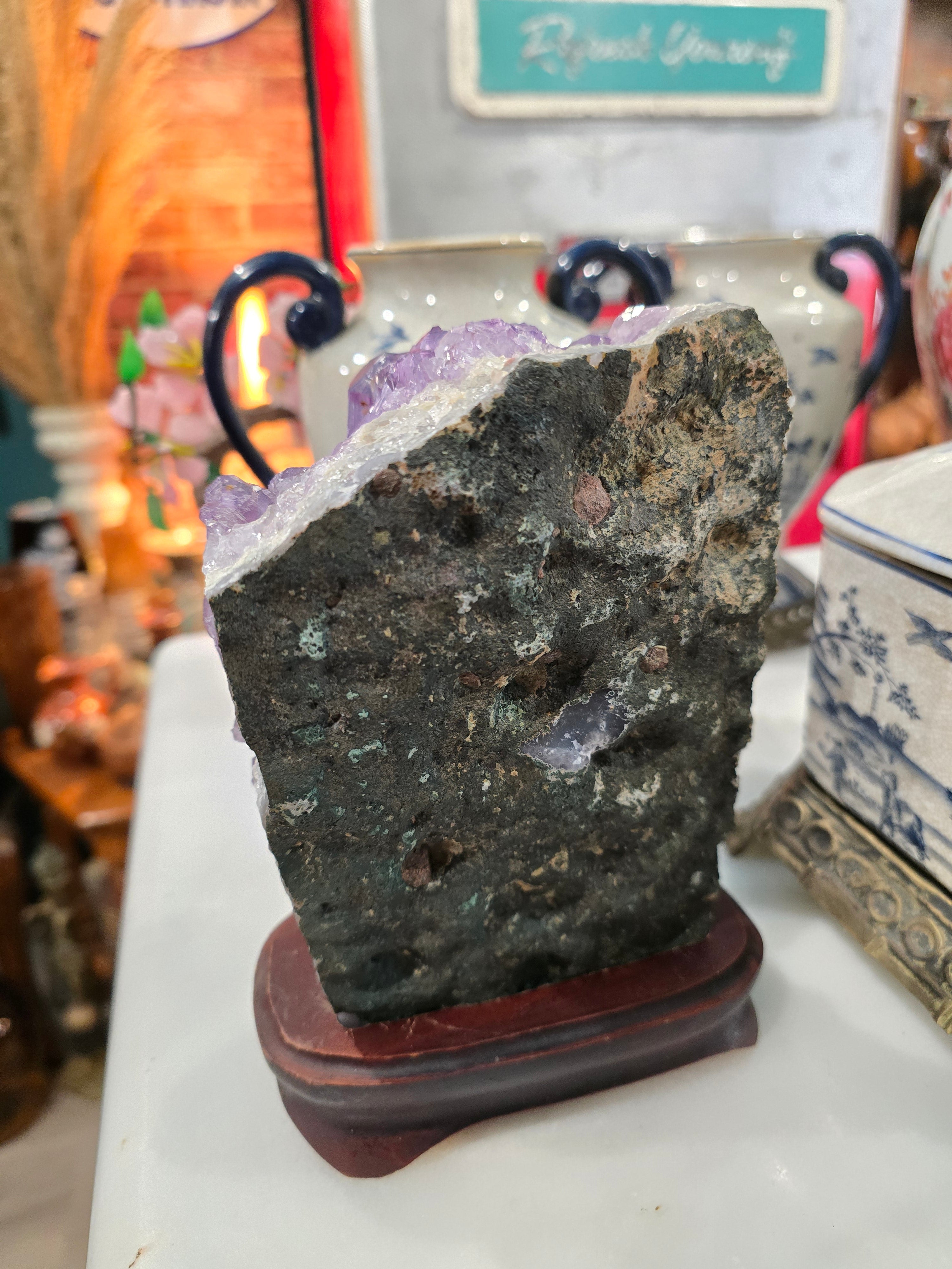 Vintage amethyst crystal cluster on a wooden stand
