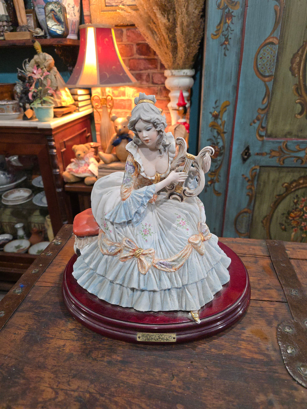 Vittorio Sabadin Italian porcelain figurine titled "Dame à la lyre"featuring a woman in a Rococo-style dress.