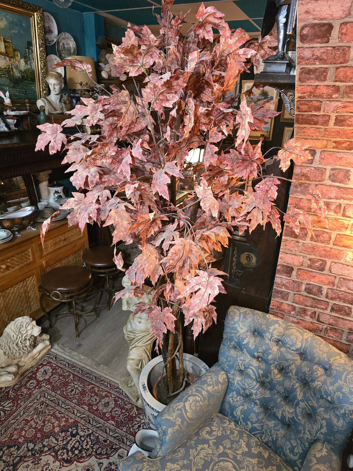 Artificial maple tree with maroon autumn-colored foliage with , blue-and-white porcelain cache-pot