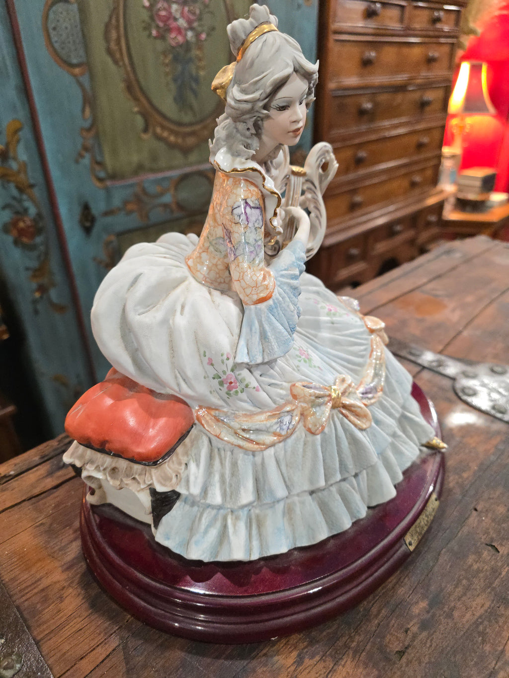 Vittorio Sabadin Italian porcelain figurine titled "Dame à la lyre"featuring a woman in a Rococo-style dress.