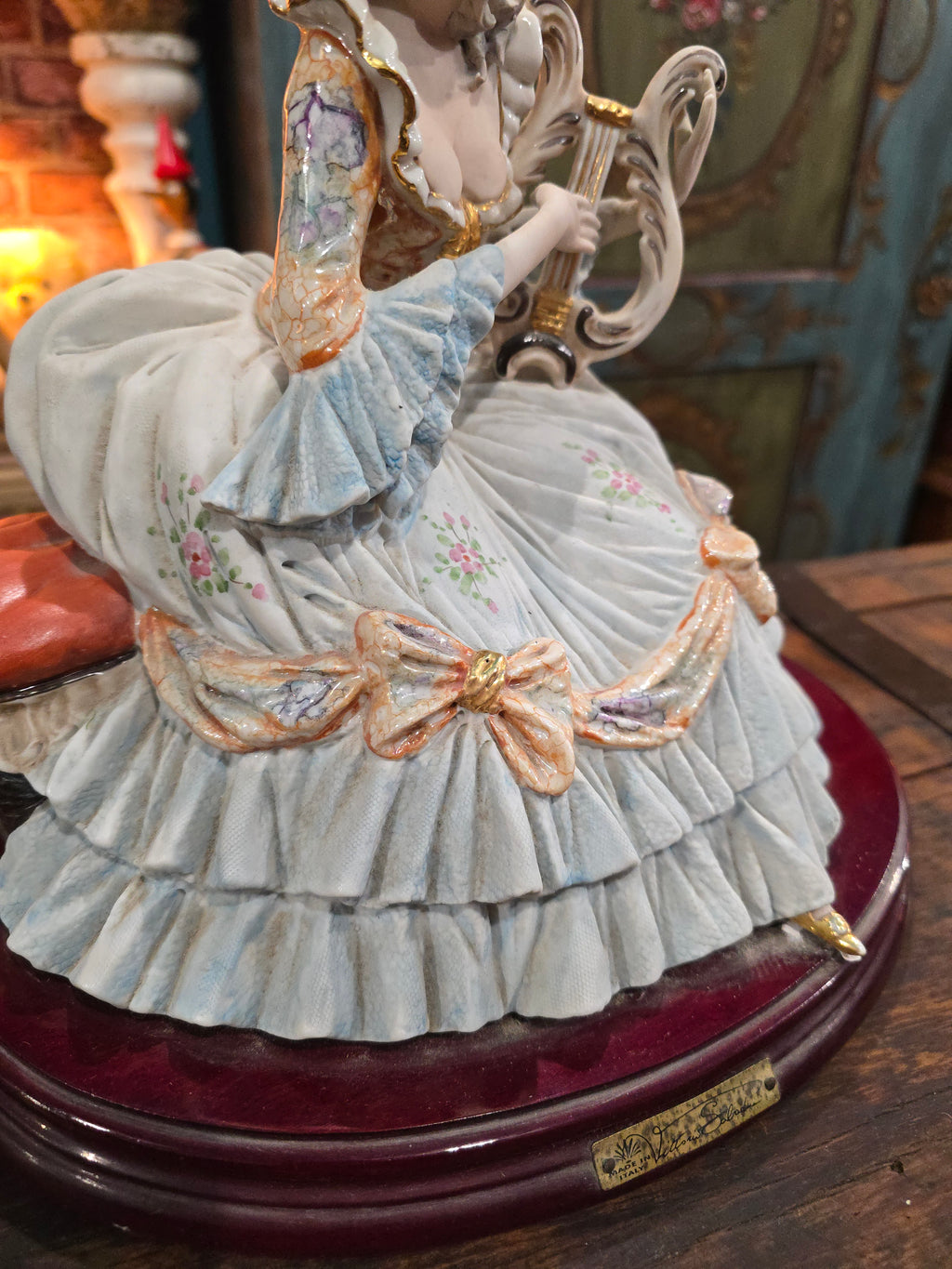 Vittorio Sabadin Italian porcelain figurine titled "Dame à la lyre"featuring a woman in a Rococo-style dress.