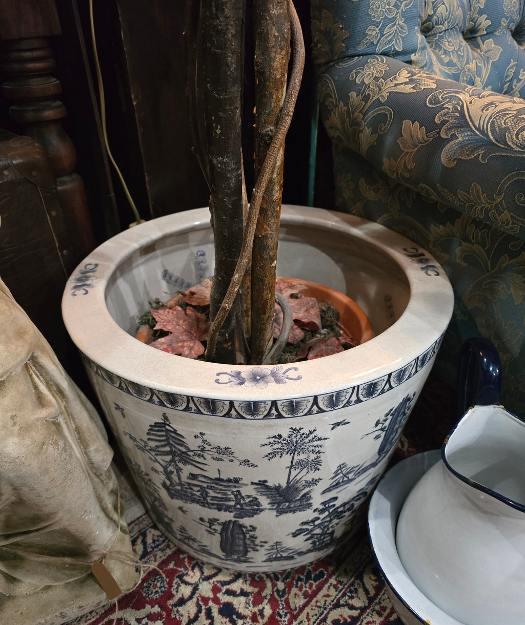 Artificial maple tree with maroon autumn-colored foliage with , blue-and-white porcelain cache-pot